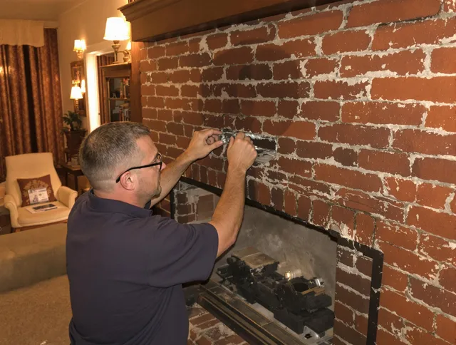 Hanson Chimney Sweep expert fixing a fireplace in Hanson, MA
